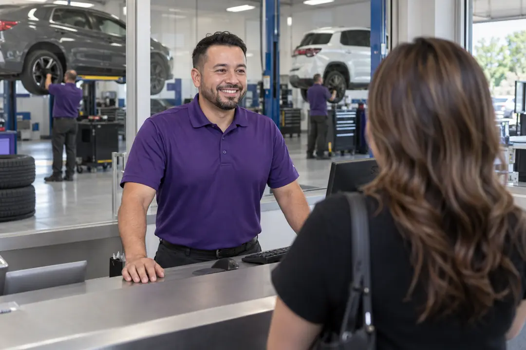 A technician greeting a customer at a service counter