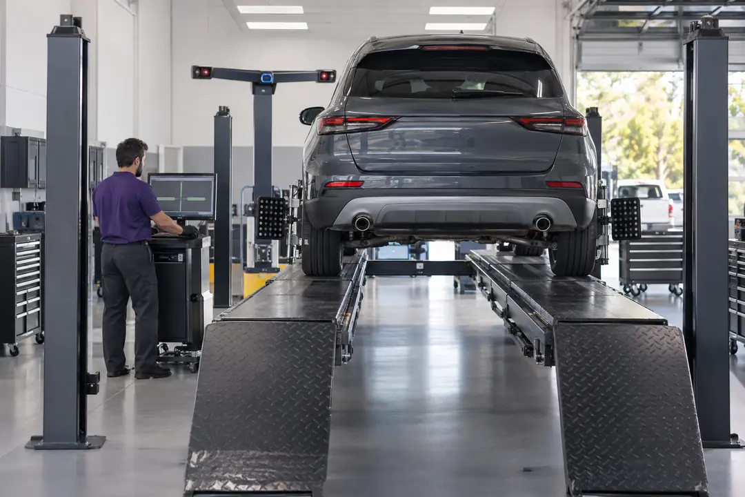 A car on an alignment rack with targets on all four wheels